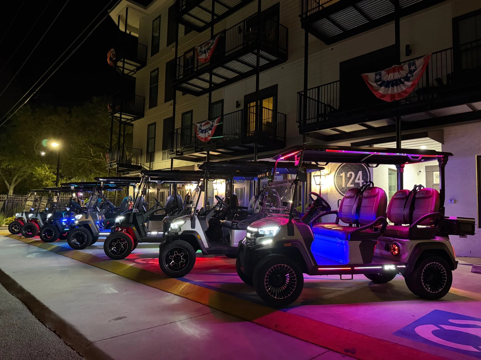 King Louis Cart Company golf carts parked in Bay St. Louis at night